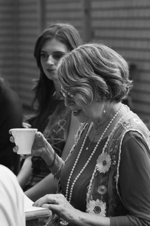 A beautifully crafted navy ceramic wedding cup, delicately held during a Jewish wedding ceremony. This handcrafted piece, with its smooth finish and timeless elegance, embodies tradition and grace. Available at Green Judaica.