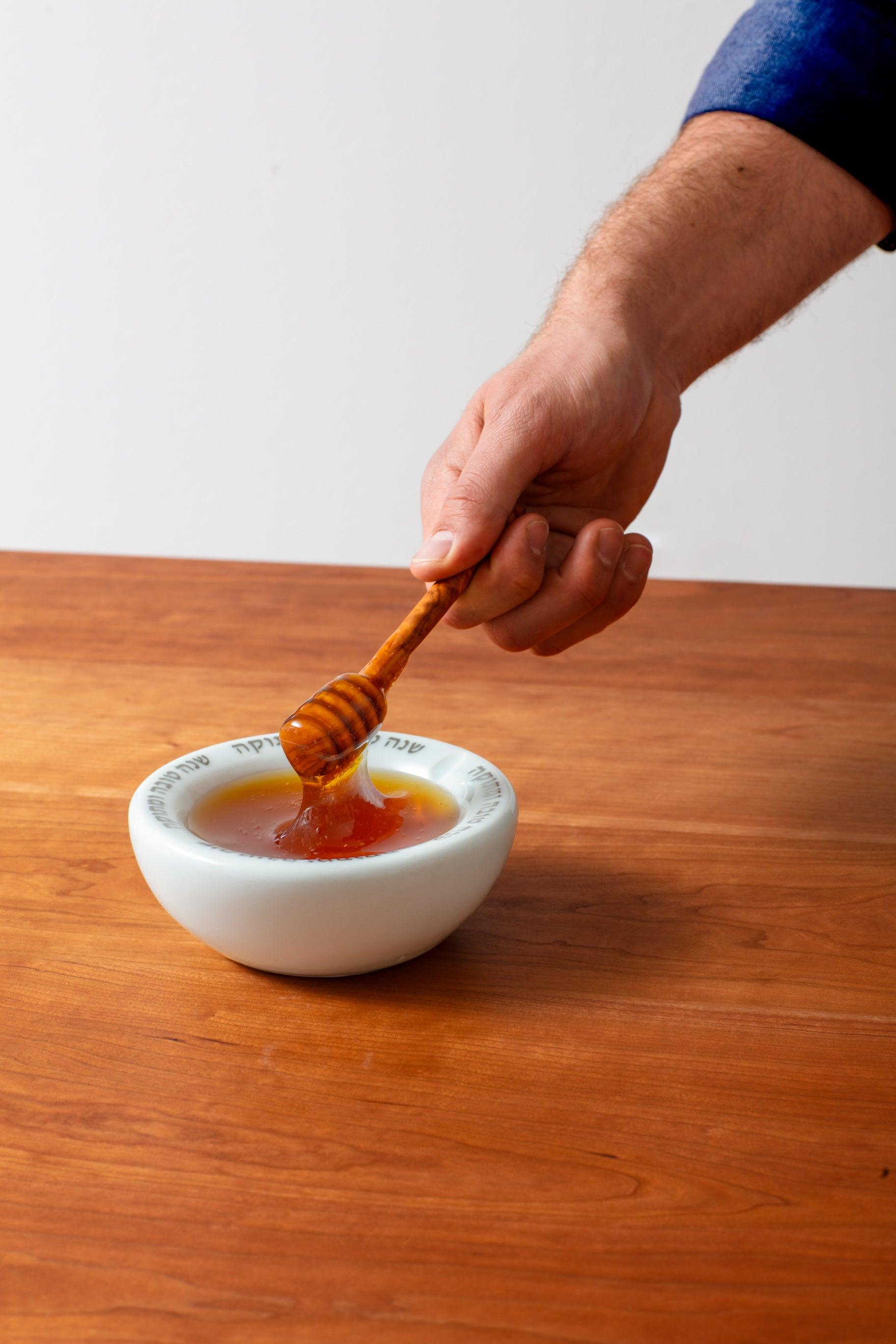 Handmade wood dipper serving honey from a handmade Honey Pot