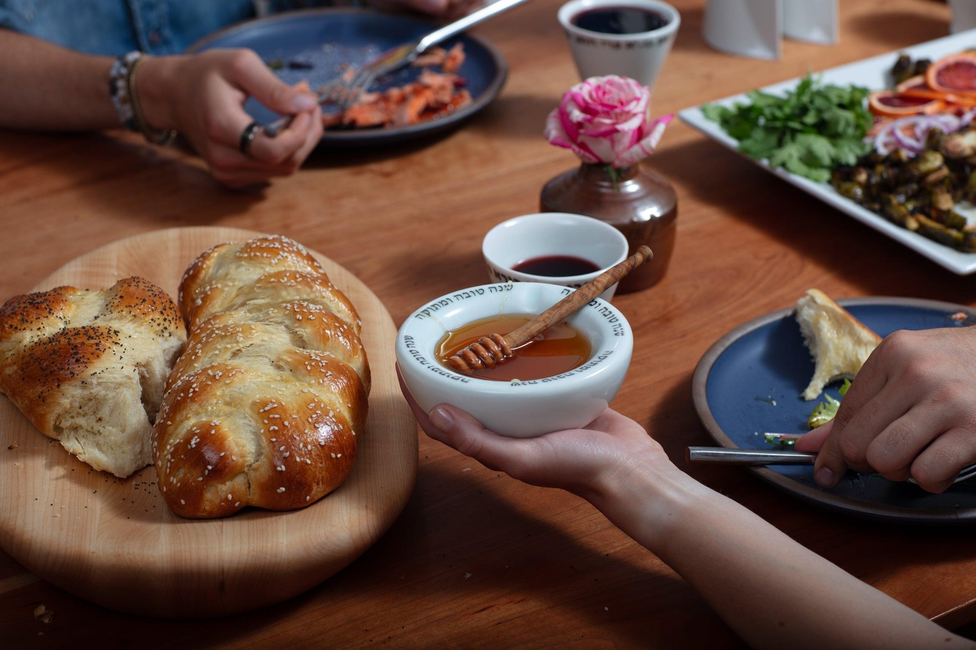 Honey Pot with honey dipper being used during Rosh Hashanah dinner 